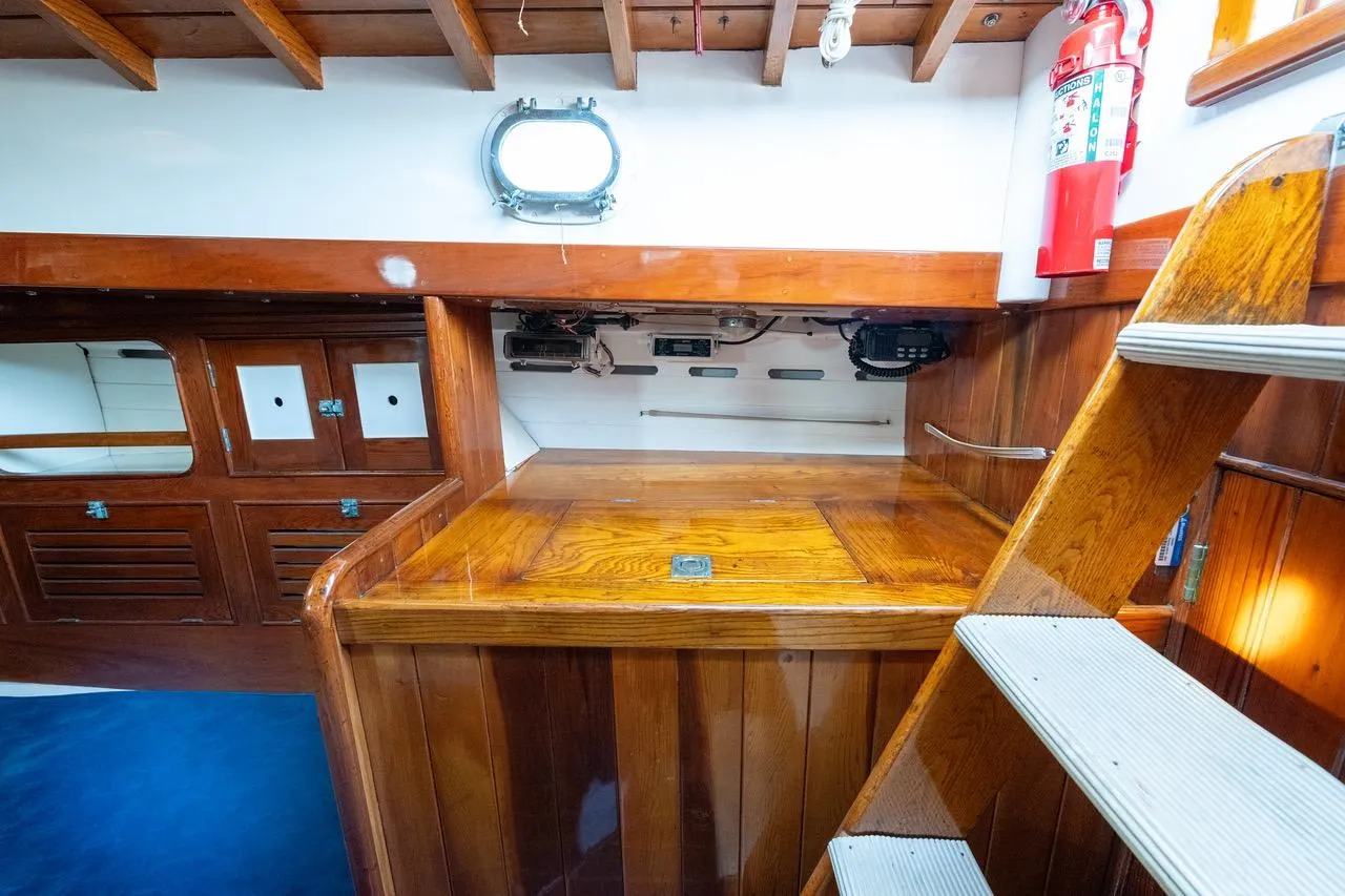 Interior of 1938 Philip Rhodes Cutter, featuring wooden cabinetry and nautical elements.