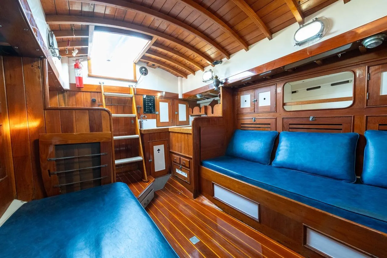 Interior of a 1938 Philip Rhodes Cutter, featuring wooden paneling and blue seating.