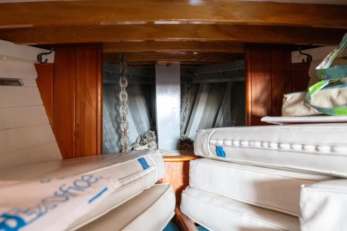 Interior of a 1938 Philip Rhodes Cutter, showing anchor chain and cushions.