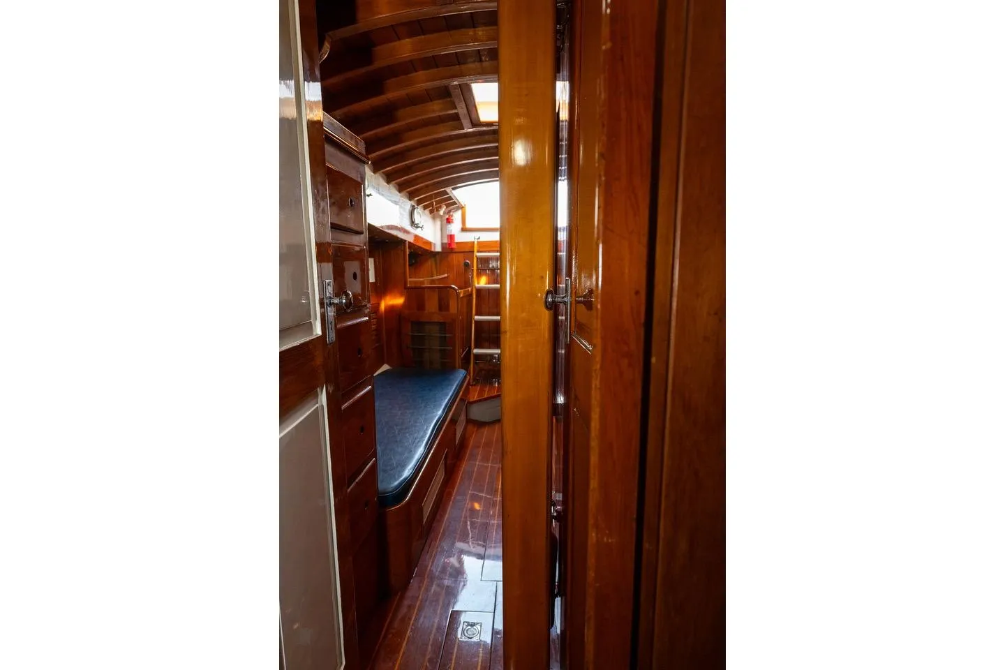 Interior of 1938 Philip Rhodes Cutter, showcasing polished wood and classic nautical design.