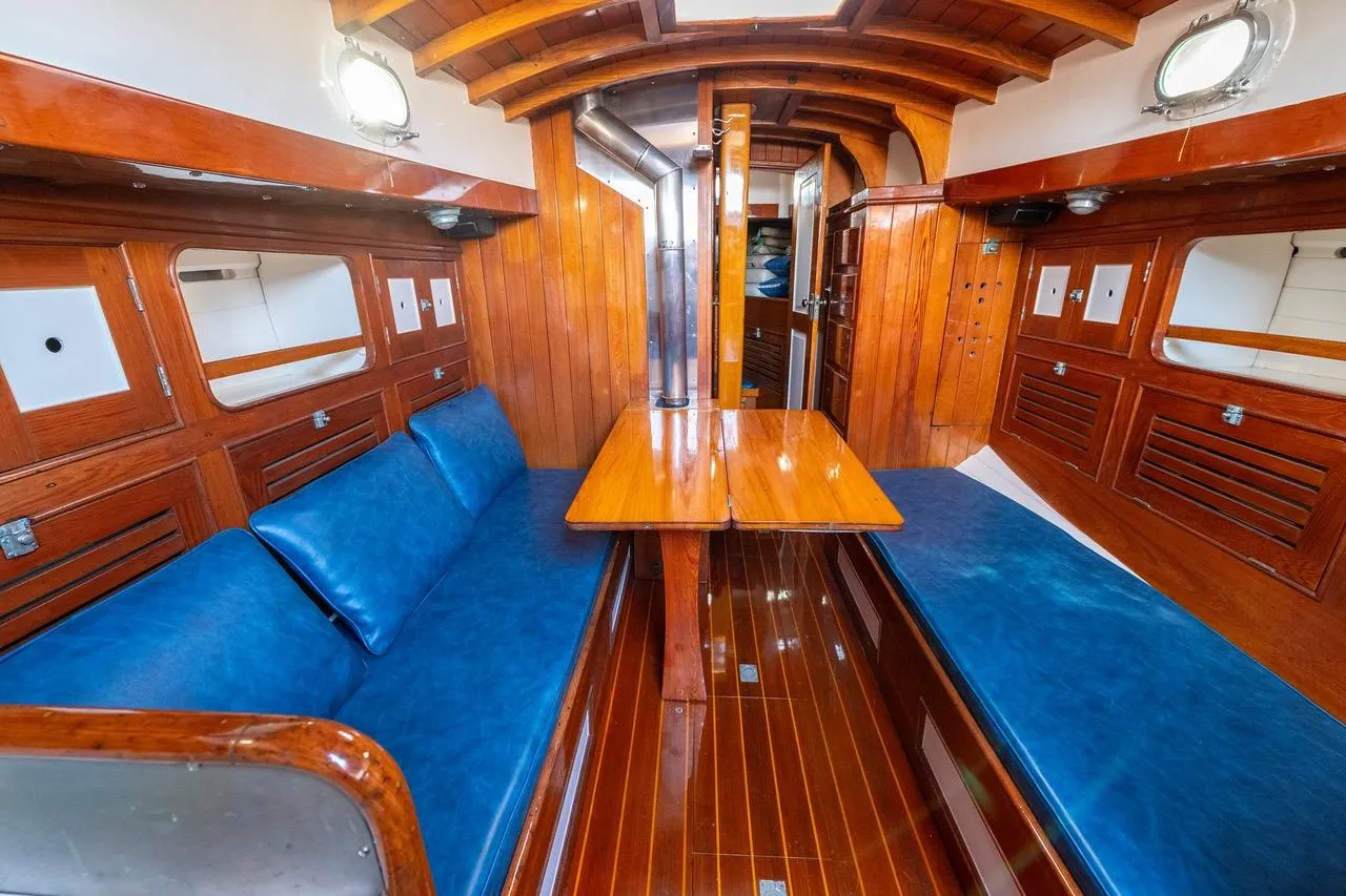 Interior of a 1938 Philip Rhodes Cutter with polished wood and blue seating.