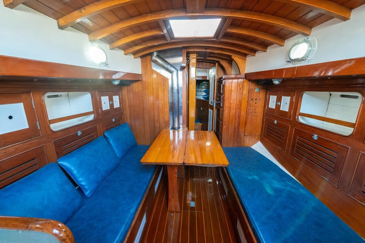 Interior of a 1938 Philip Rhodes Cutter, featuring wooden paneling and blue seating.