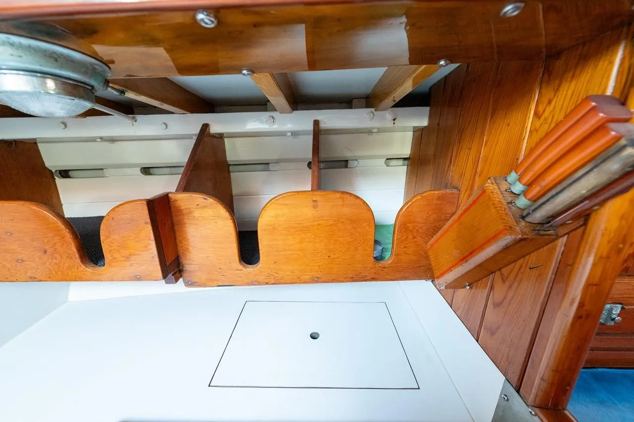 Interior view of a 1938 Philip Rhodes Cutter, showcasing wooden craftsmanship and storage compartments.
