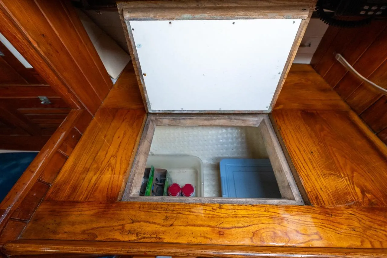 Wooden interior storage compartment on a 1938 Philip Rhodes Cutter sailboat.