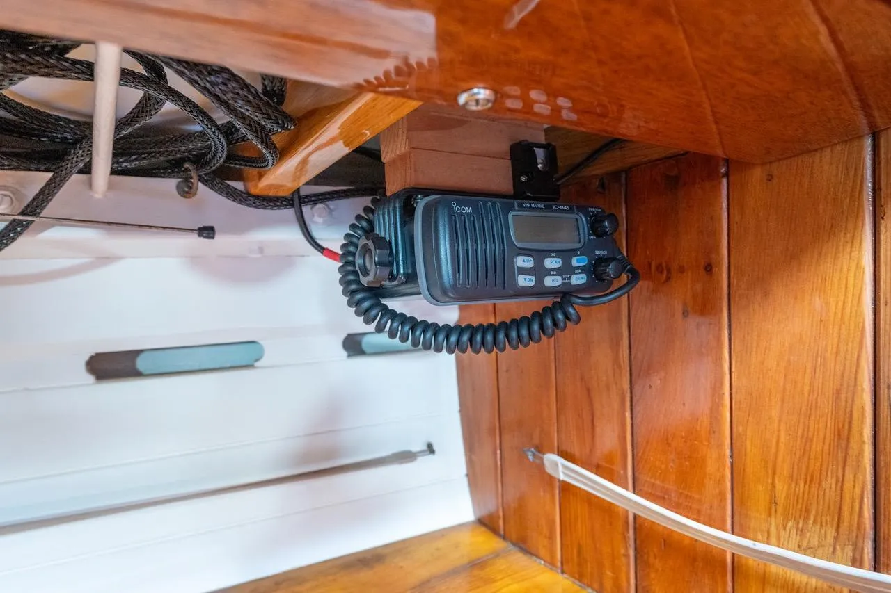 Radio equipment inside a 1938 Philip Rhodes Cutter boat, featuring wooden interior.