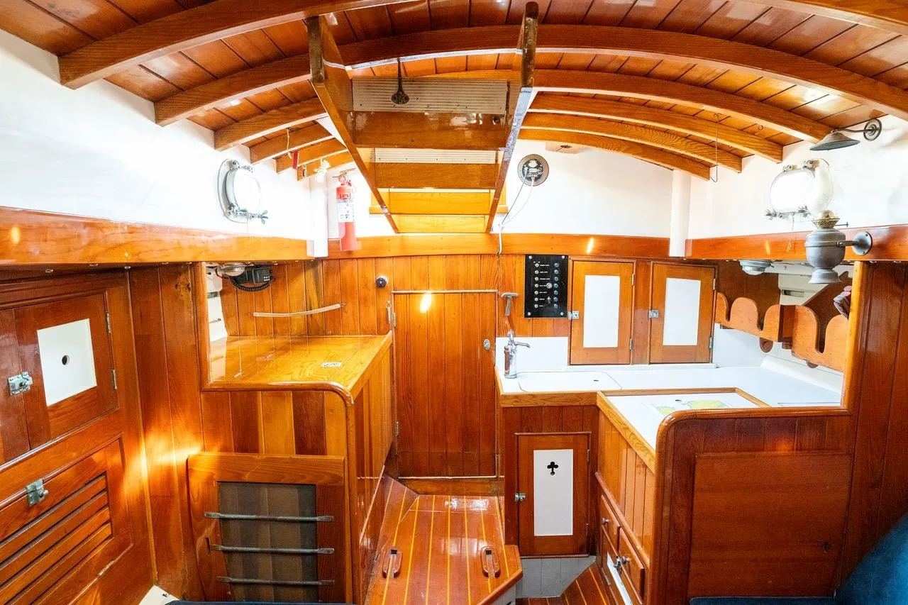 1938 Philip Rhodes Cutter interior with wooden cabinetry and classic nautical design.