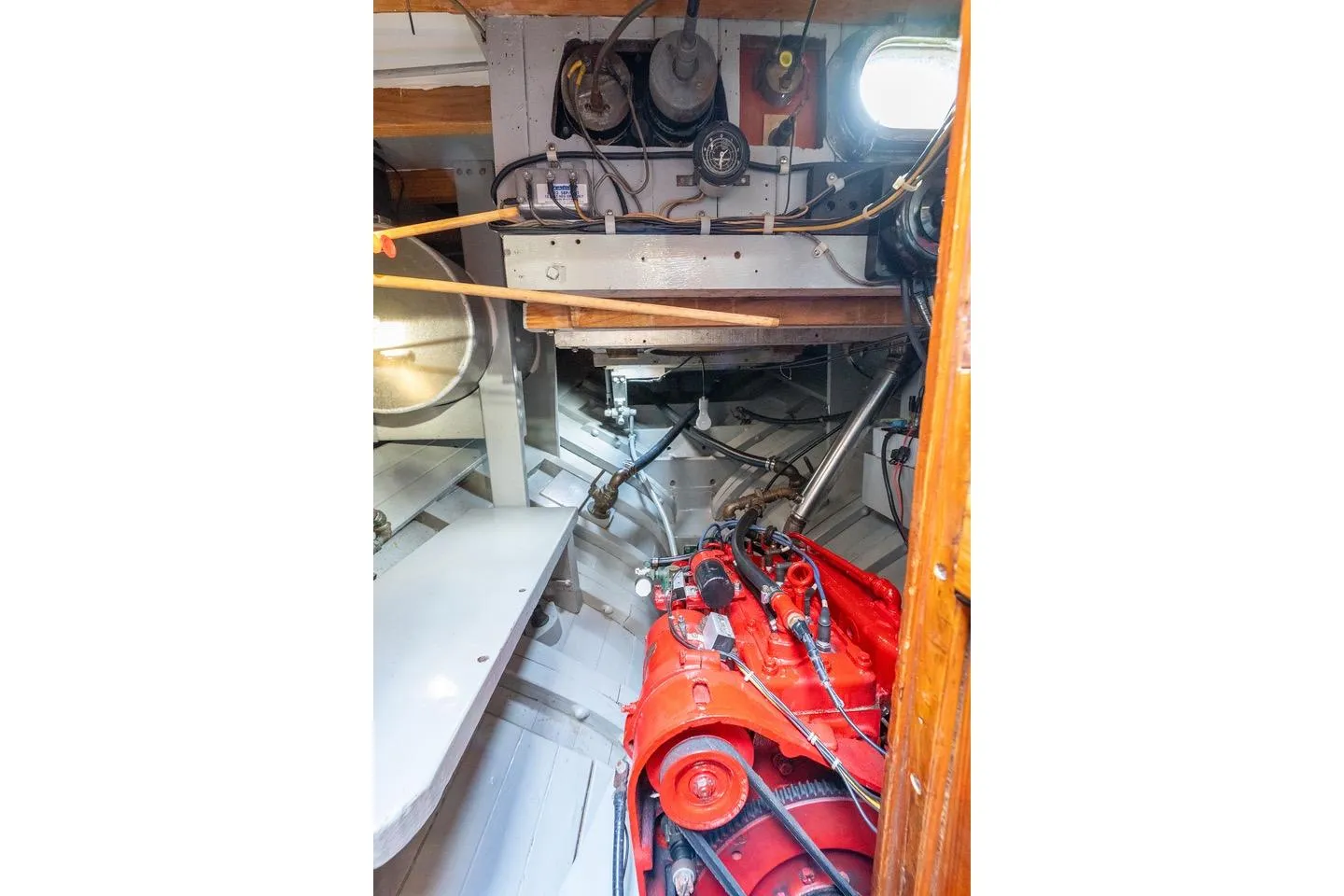 Engine room of a 1938 Philip Rhodes Cutter with visible red engine components.