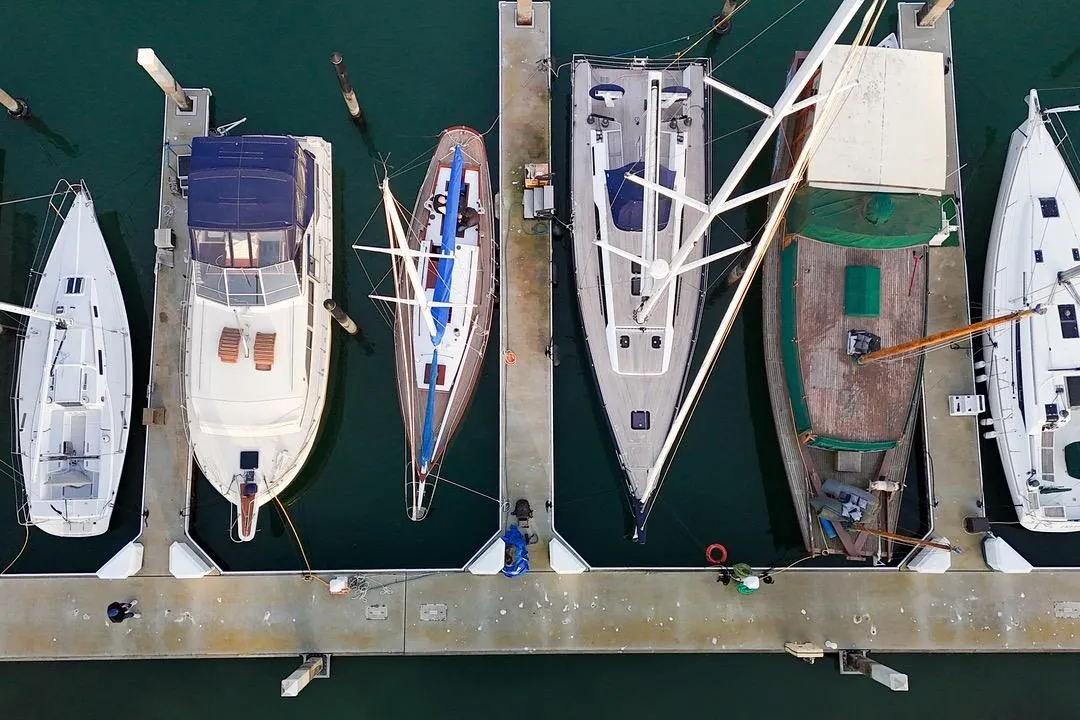 Aerial view of boats docked at a marina, featuring a 1938 Philip Rhodes Cutter.