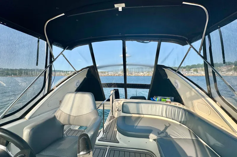  Yacht Photos Pics Interior view of 2003 Meridian 341 Sedan boat with seating and scenic water backdrop.