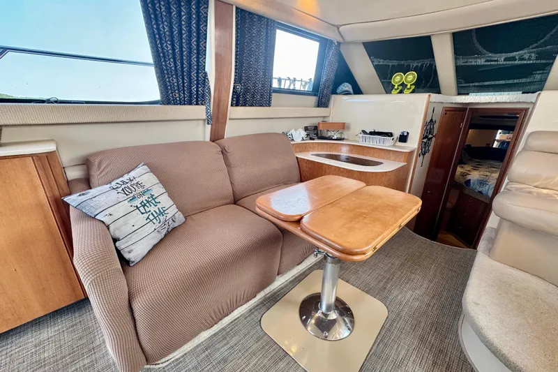  Yacht Photos Pics Interior of 2003 Meridian 341 Sedan yacht with cozy seating and wooden table.