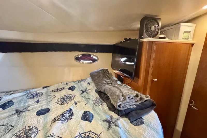  Yacht Photos Pics Cozy cabin interior of 2003 Meridian 341 Sedan with nautical-themed bedding and modern amenities.