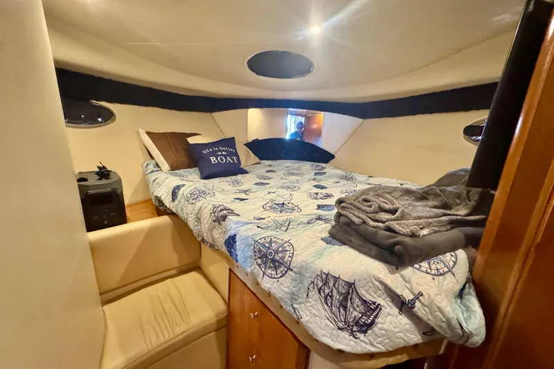  Yacht Photos Pics Cozy cabin interior of 2003 Meridian 341 Sedan with nautical-themed bedding.