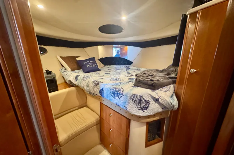  Yacht Photos Pics Cozy bedroom in 2003 Meridian 341 Sedan yacht with nautical-themed bedding.