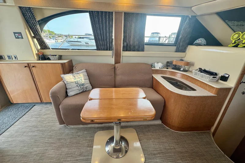  Yacht Photos Pics Interior of a 2003 Meridian 341 Sedan yacht with cozy seating and wooden table.