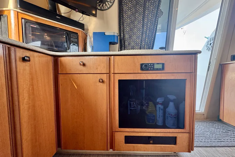 Yacht Photos Pics Interior of a 2003 Meridian 341 Sedan with wooden cabinetry and appliances.