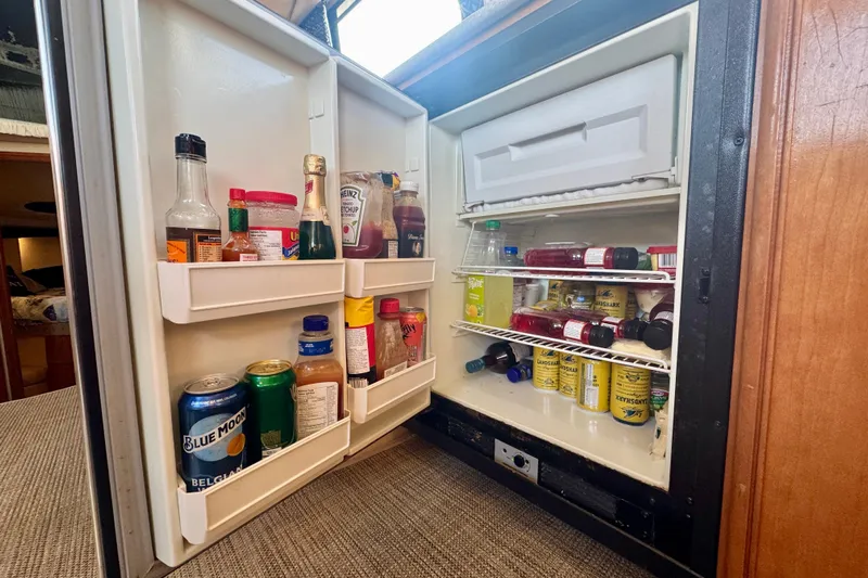  Yacht Photos Pics Open fridge in 2003 Meridian 341 Sedan, stocked with beverages and condiments.