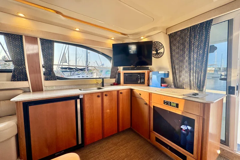  Yacht Photos Pics Interior of 2003 Meridian 341 Sedan yacht with kitchenette and marina view.