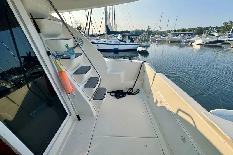  Yacht Photos Pics 2003 Meridian 341 Sedan yacht deck with marina view, featuring steps and mooring equipment.