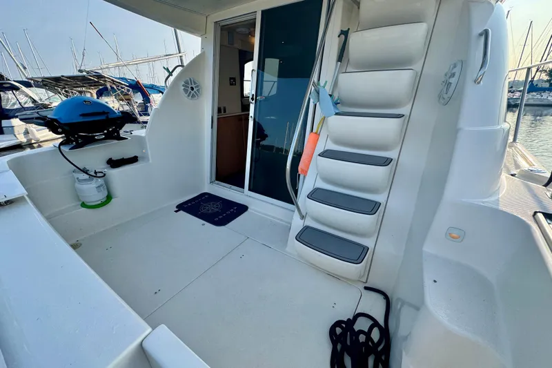  Yacht Photos Pics 2003 Meridian 341 Sedan yacht deck with stairs, grill, and marina view.