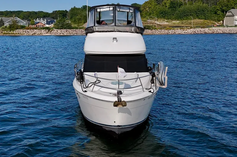  Yacht Photos Pics 2003 Meridian 341 Sedan yacht on calm water, scenic shoreline background.