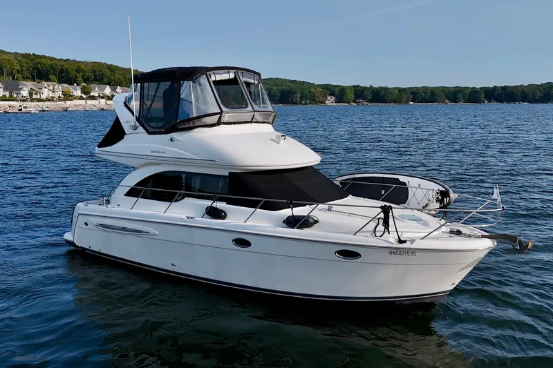  Yacht Photos Pics 2003 Meridian 341 Sedan yacht on a serene lake with scenic shoreline.