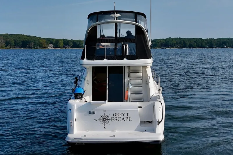  Yacht Photos Pics 2003 Meridian 341 Sedan boat on a lake, rear view with "Grey-T Escape" text.
