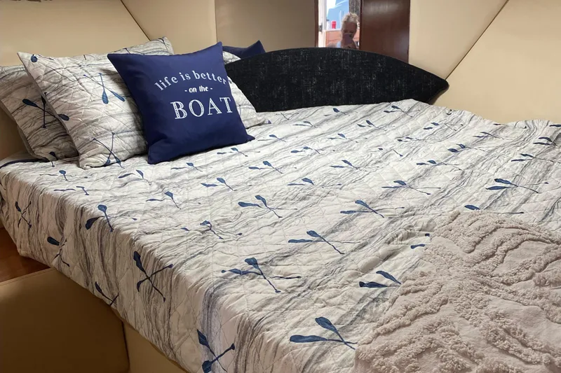  Yacht Photos Pics Cozy bedroom in 2003 Meridian 341 Sedan with nautical-themed bedding and decorative pillows.