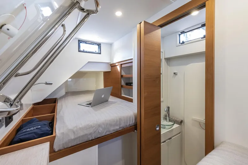 Yacht Photos Pics 2024 Pardo Yachts E60 cabin interior with bed, laptop, and compact bathroom.