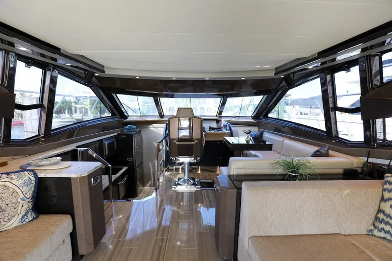  Yacht Photos Pics Luxurious interior of 2016 Marquis 660 Sport Yacht with modern seating and panoramic windows.