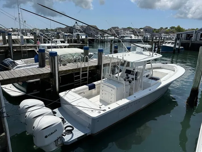 Distraction Yacht Photos Pics 2019 Regulator 34SS boat docked at a marina with Yamaha engines.