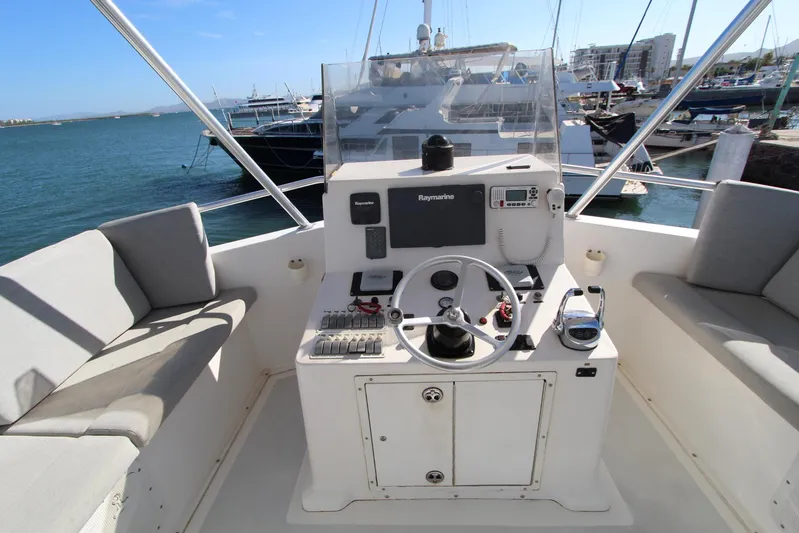  Yacht Photos Pics 2006 Island Hopper Sportfisher boat helm with steering wheel and navigation equipment.