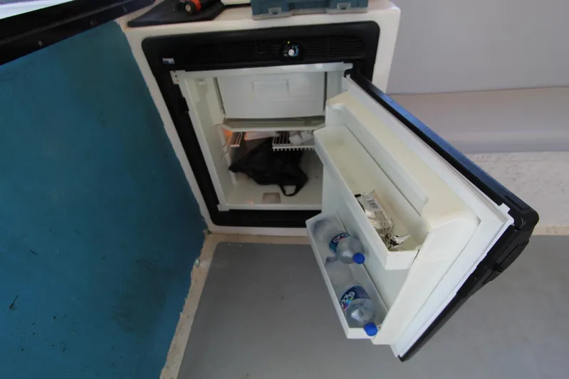  Yacht Photos Pics Open mini fridge on 2006 Island Hopper Sportfisher boat, containing water bottles and snacks.
