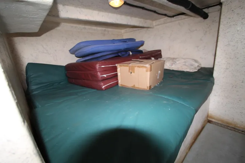  Yacht Photos Pics 2006 Island Hopper Sportfisher cabin interior with cushions and a cardboard box.