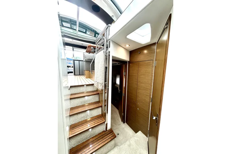  Yacht Photos Pics Interior of 2014 Cruisers Yachts 45 Cantius with wooden stairs and modern design.