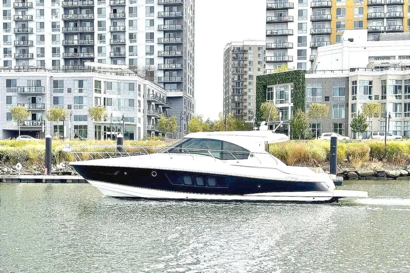  Yacht Photos Pics 2014 Cruisers Yachts 45 Cantius on water, urban skyline background.