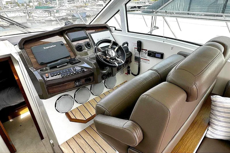  Yacht Photos Pics 2014 Cruisers Yachts 45 Cantius helm with leather seats and modern controls.