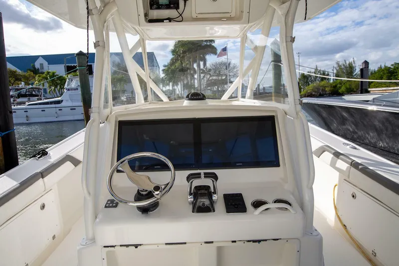 Evil Tequila Yacht Photos Pics 2015 Yellowfin 39 Offshore boat helm with steering wheel and navigation display.