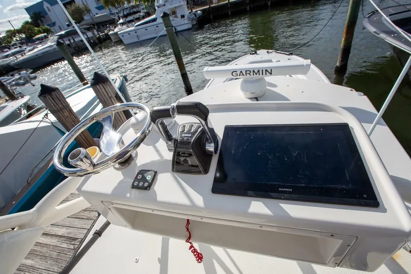 Evil Tequila Yacht Photos Pics 2015 Yellowfin 39 Offshore boat helm with Garmin navigation system at marina.