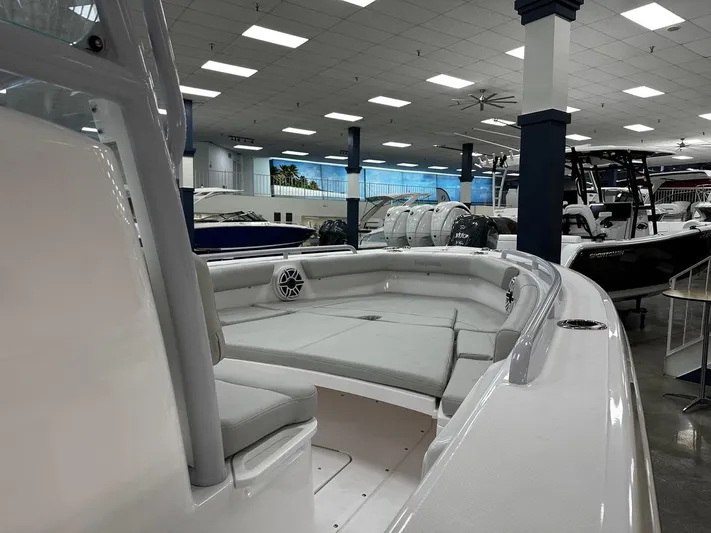  Yacht Photos Pics 2023 Everglades 243 Center Console boat interior in showroom, featuring spacious seating and modern design.