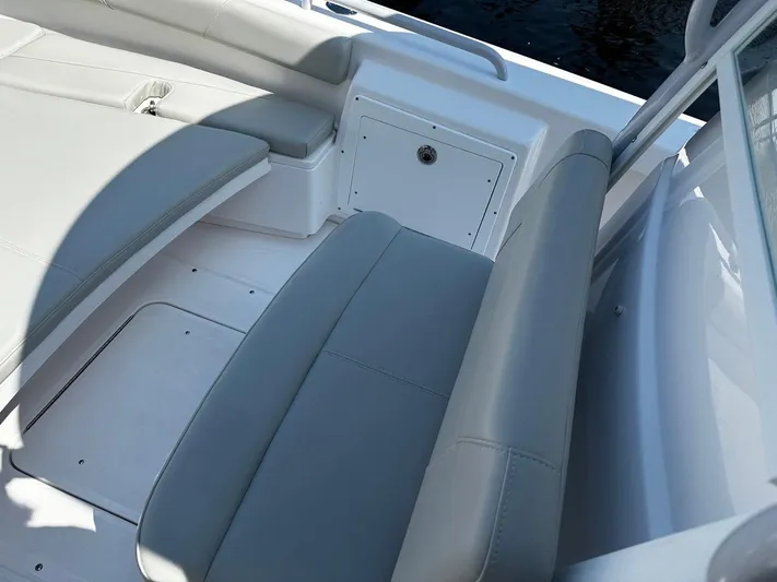 Yacht Photos Pics 2023 Everglades 243 Center Console boat interior with gray seating and storage compartment.