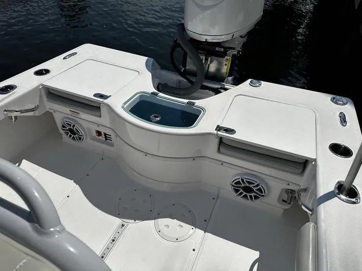  Yacht Photos Pics 2023 Everglades 243 Center Console boat interior with storage and speakers.
