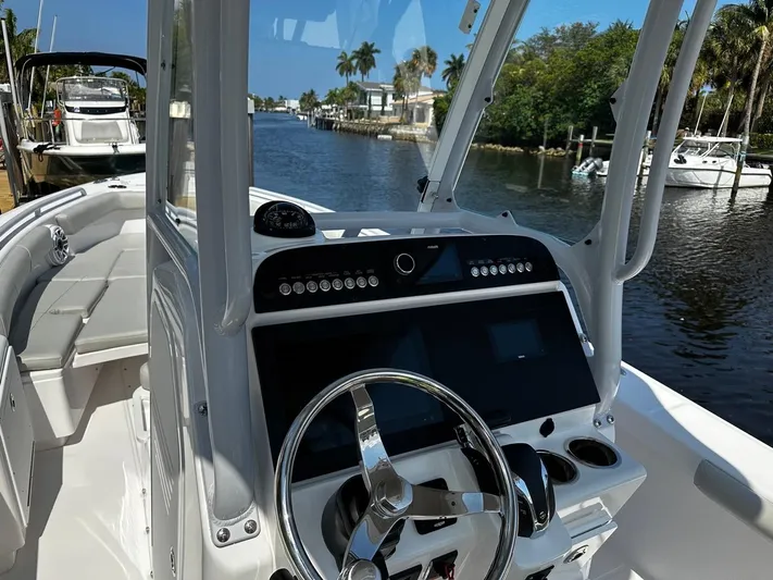  Yacht Photos Pics 2023 Everglades 243 Center Console boat interior with steering wheel and control panel.