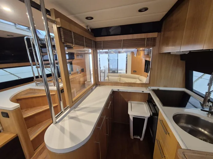  Yacht Photos Pics Luxurious 1998 Riva Dolce Vita yacht interior with modern kitchen and wooden finishes.