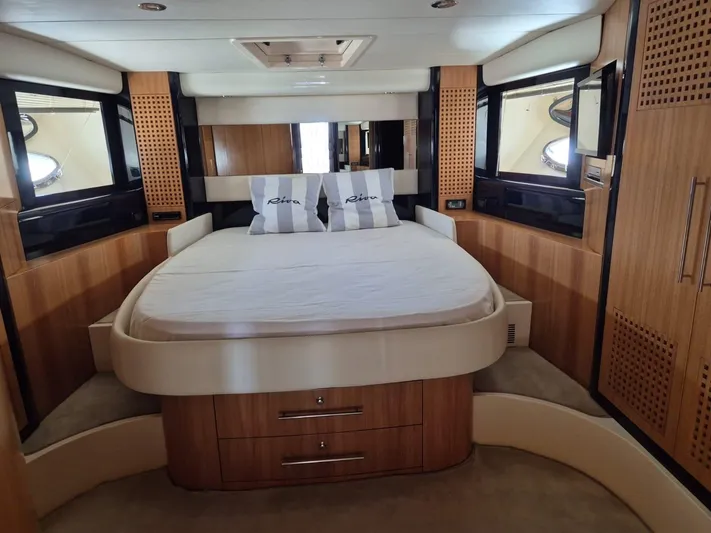  Yacht Photos Pics Luxurious cabin interior of a 1998 Riva Dolce Vita yacht with elegant wood finishes.