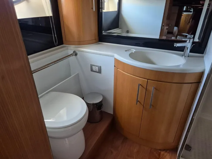  Yacht Photos Pics Luxurious 1998 Riva Dolce Vita yacht bathroom with wooden cabinetry and modern fixtures.