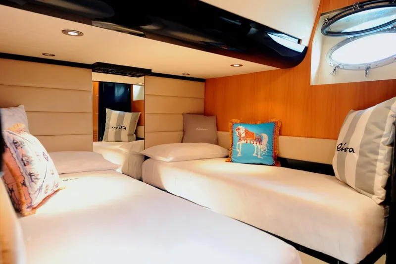  Yacht Photos Pics Luxurious cabin interior of 1998 Riva Dolce Vita yacht with twin beds and decorative pillows.