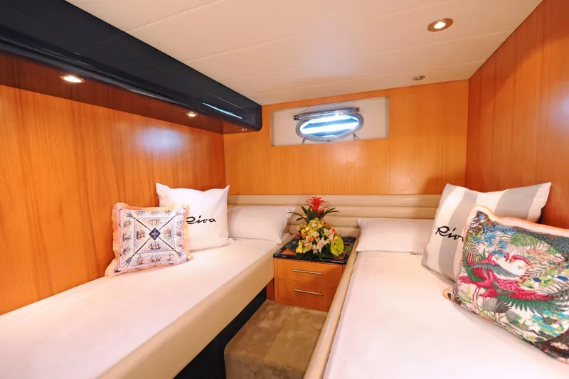  Yacht Photos Pics Luxurious cabin interior of 1998 Riva Dolce Vita yacht with twin beds and decorative pillows.