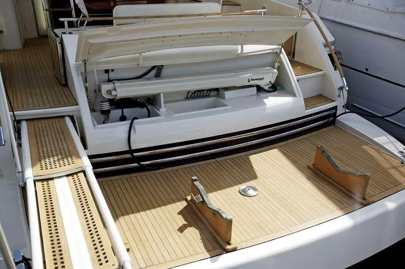  Yacht Photos Pics 1998 Riva Dolce Vita yacht deck with open storage compartment and wooden flooring.