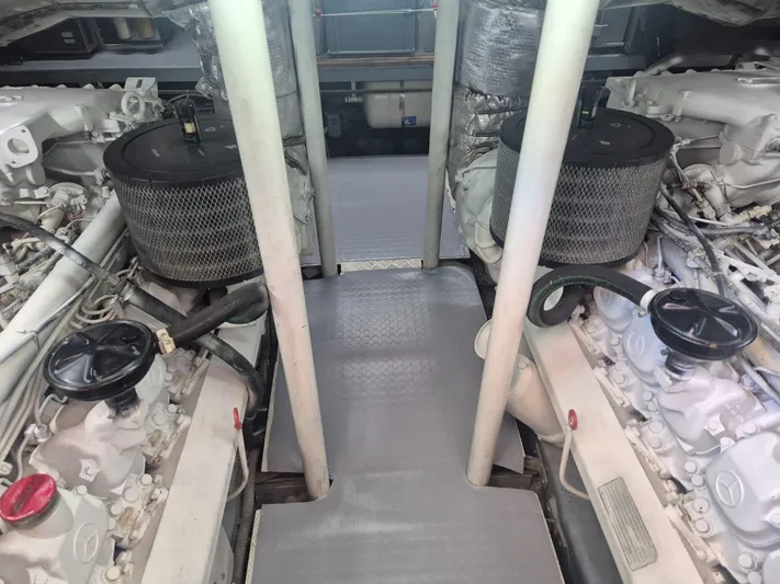  Yacht Photos Pics Engine room of a 1998 Riva Dolce Vita yacht, showcasing dual engines and mechanical components.