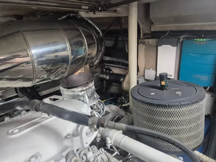  Yacht Photos Pics Engine compartment of a 1998 Riva Dolce Vita yacht, showcasing mechanical components and systems.